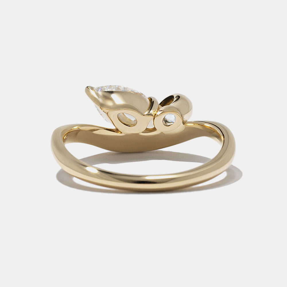 0.7 carat pear and oval lab diamond Toi Et Moi engagement ring in polished gold bezel setting minimalist design