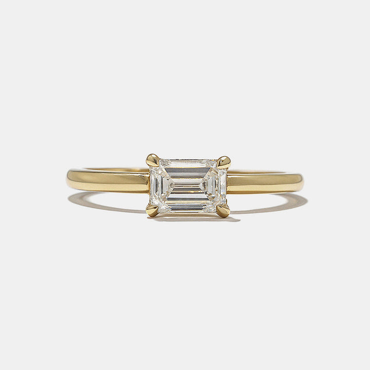 Front view of 0.75 carat east west emerald cut lab grown diamond hidden halo engagement ring with horizontal modern design