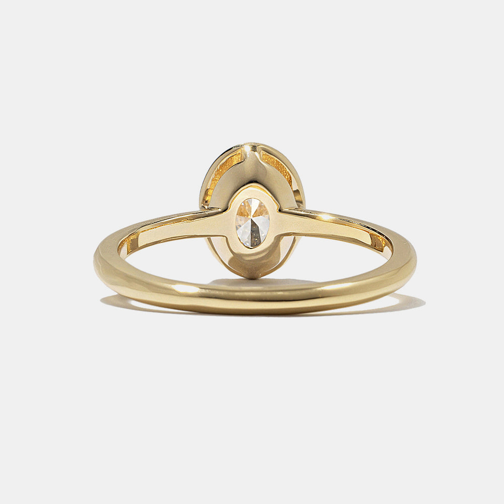 0.75 carat oval E VS lab grown diamond bezel engagement ring in minimal polished gold band