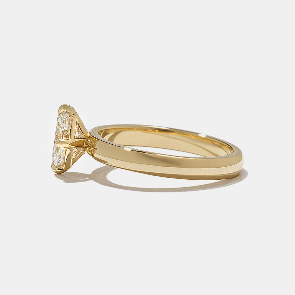 Side profile of oval cut lab grown diamond solitaire engagement ring with sleek modern minimalist setting