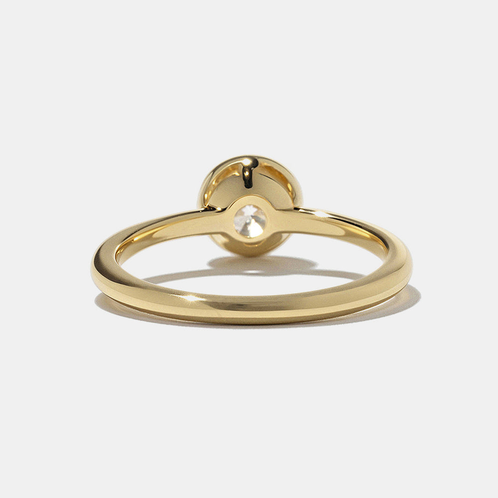 0.75 carat round E VS lab grown diamond bezel engagement ring featuring minimalist and modern bridal style