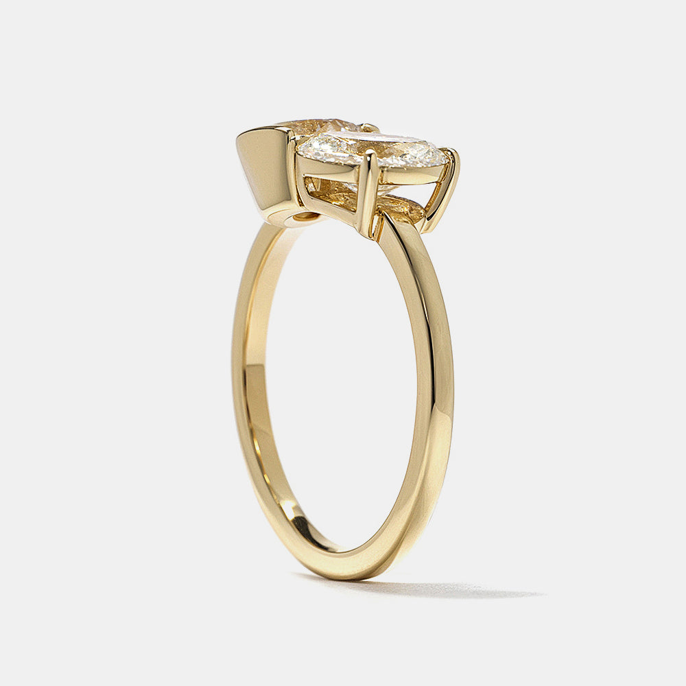 0.8 carat round and oval lab diamond Toi Et Moi engagement ring in polished gold bezel setting minimalist design
