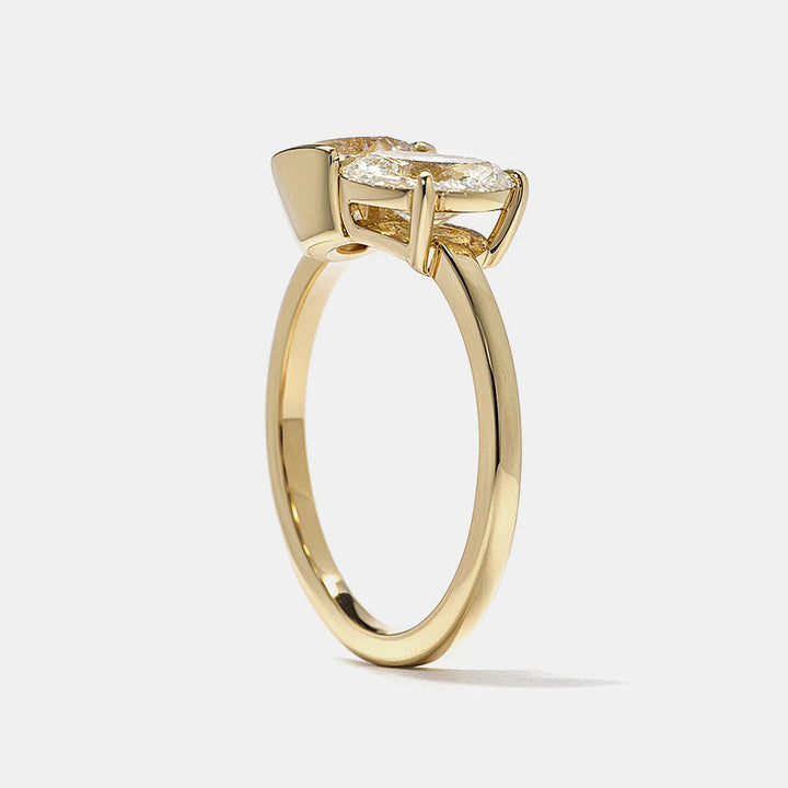 0.8 carat round and oval lab diamond Toi Et Moi engagement ring in polished gold bezel setting minimalist design