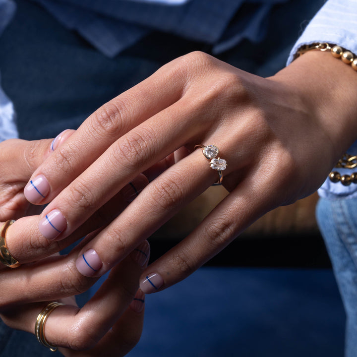 Professional jewelry photography of 0.8 carat round and emerald cut lab grown diamond bezel Toi Et Moi engagement ring