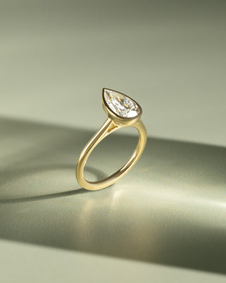 1.50 carat pear lab grown diamond cathedral engagement ring crafted in polished gold with contemporary elegance
