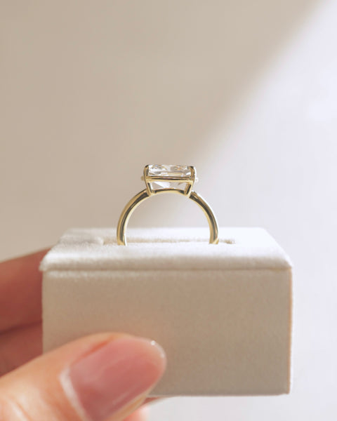 Professional jewelry photography of a 1.50 carat bezel set elongated cushion lab diamond east west engagement ring