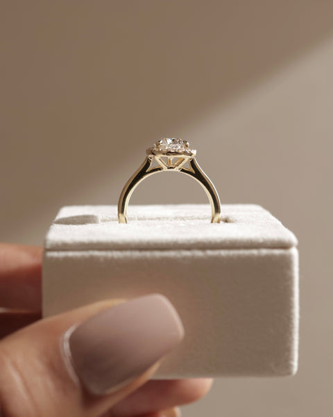 Professional jewelry photography of a 1.50 carat round lab diamond halo pavé engagement ring in studio lighting