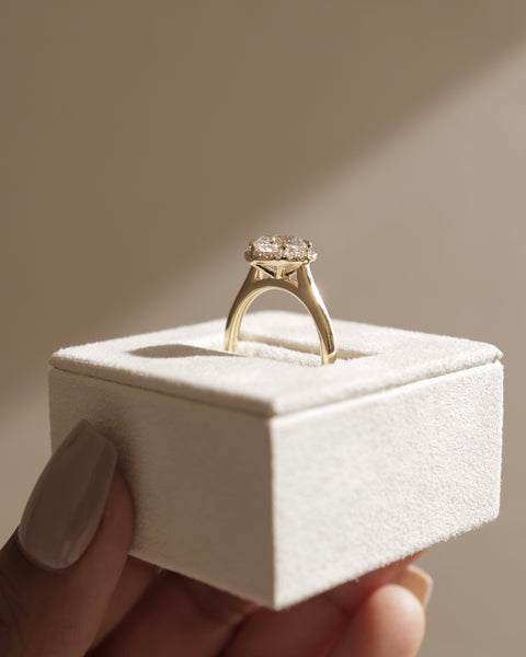 Professional jewelry photography of a 1.50 carat round lab diamond halo solitaire engagement ring in studio lighting