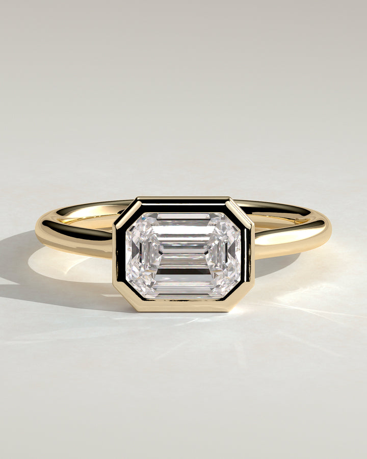 1.5ct East West Emerald Cut E/VS2 Bezel Setting Engagement Ring