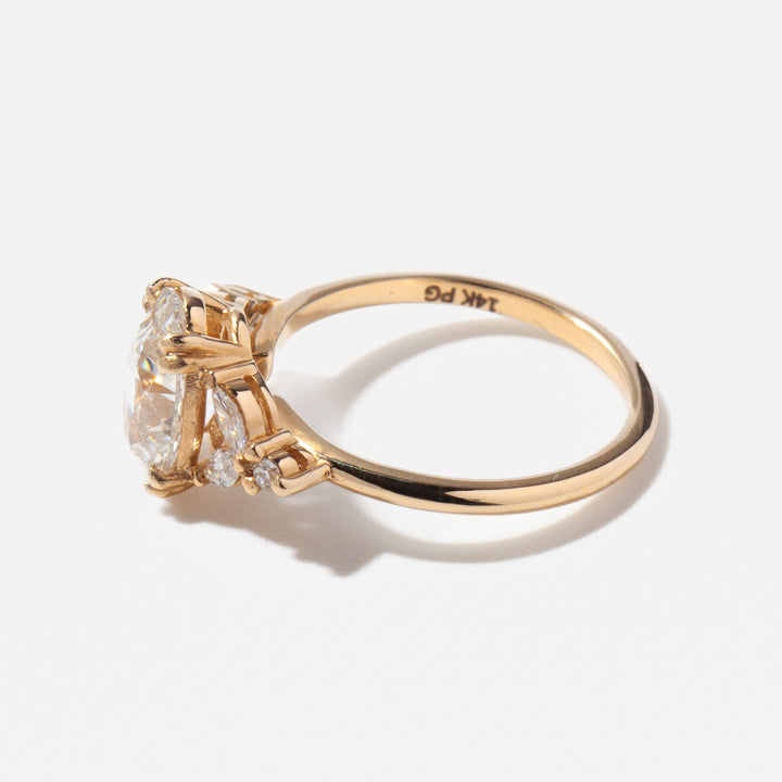 2 carat oval lab grown diamond cluster engagement ring set in polished gold with modern bridal design structure