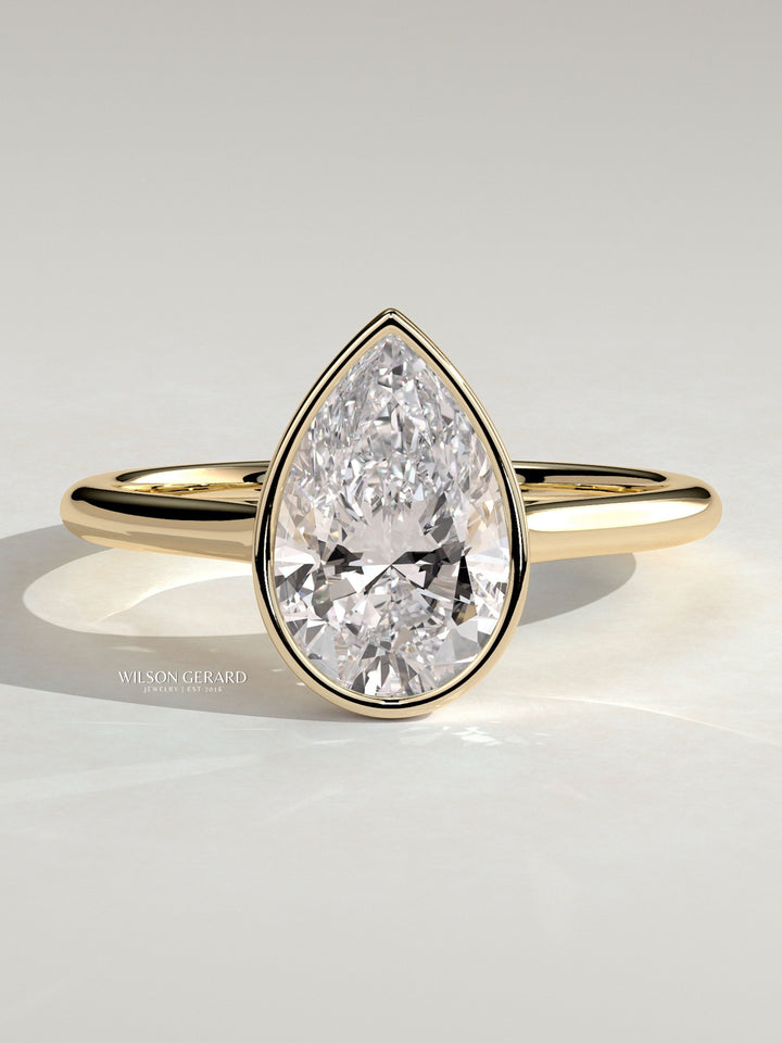 pear solitaire engagement ring bezel set