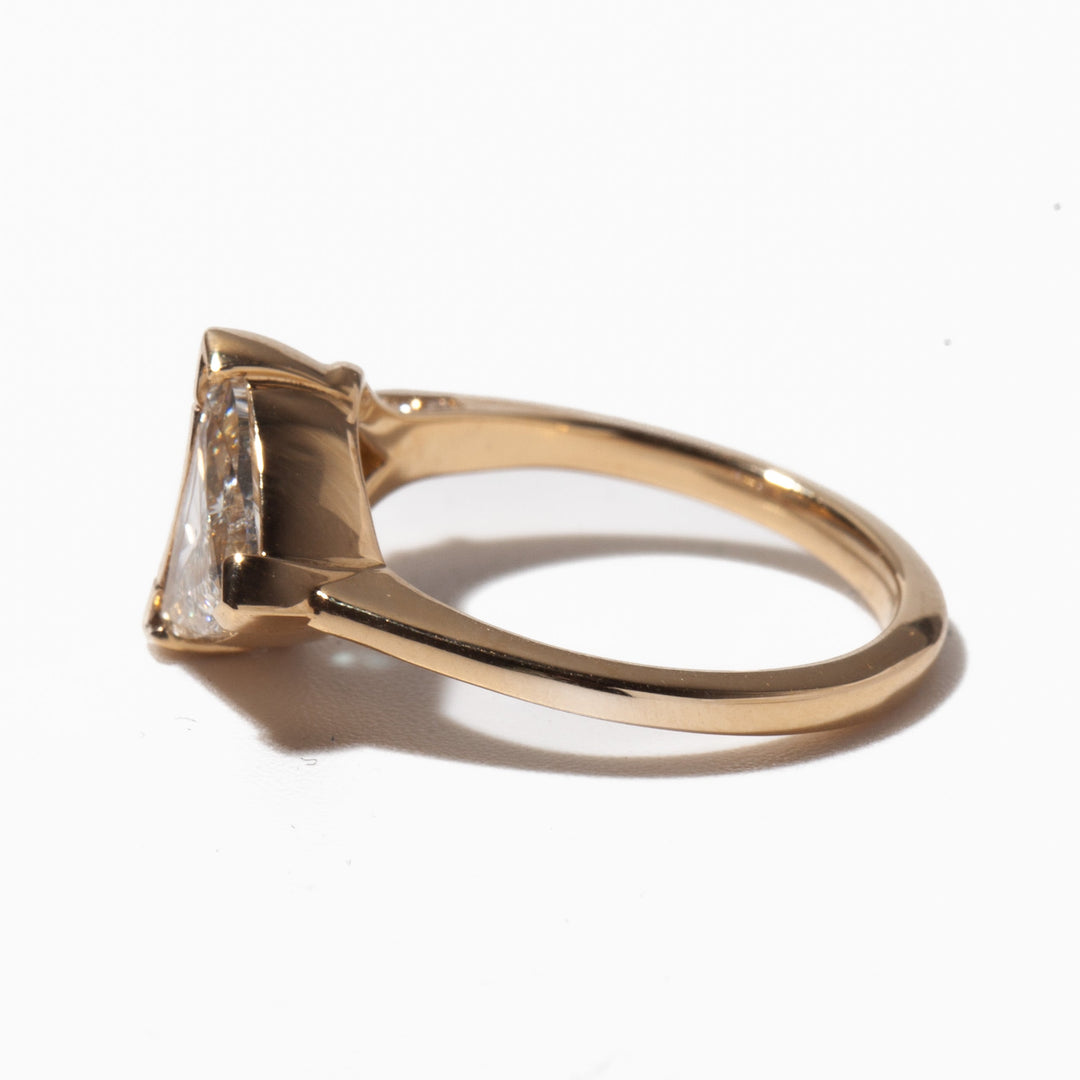 Side profile of trillion cut lab diamond and teal sapphire engagement ring showing modern asymmetric gemstone layout