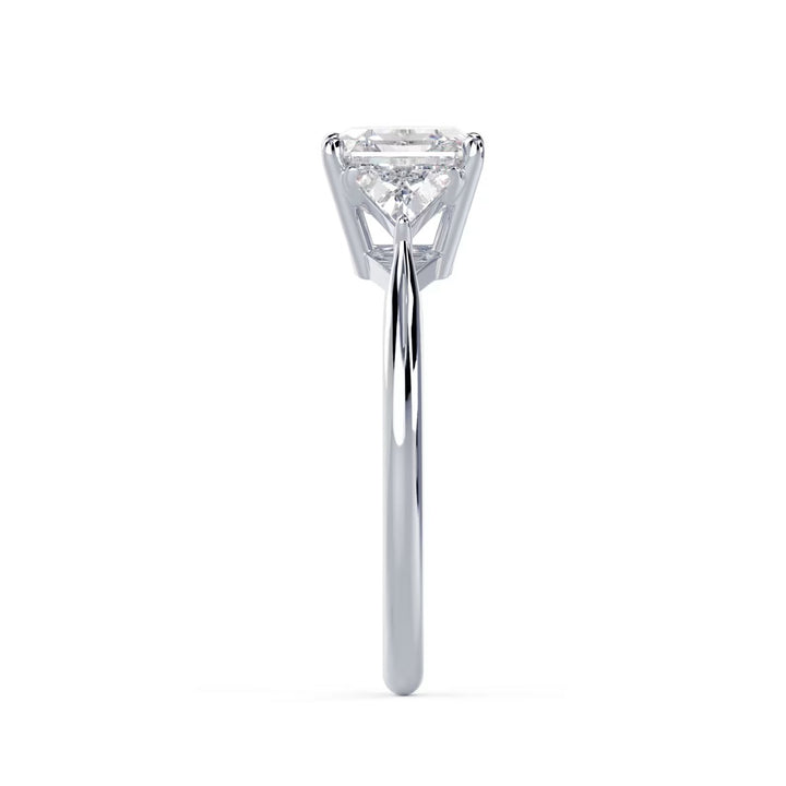 Side profile of Asscher cut lab grown diamond three stone engagement ring highlighting elegant prong setting and structure