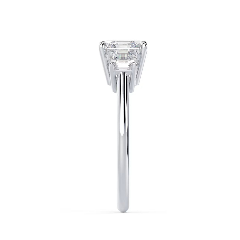 Close-up of an Asscher cut lab grown diamond three stone engagement ring showcasing step-cut brilliance and E VS1 clarity