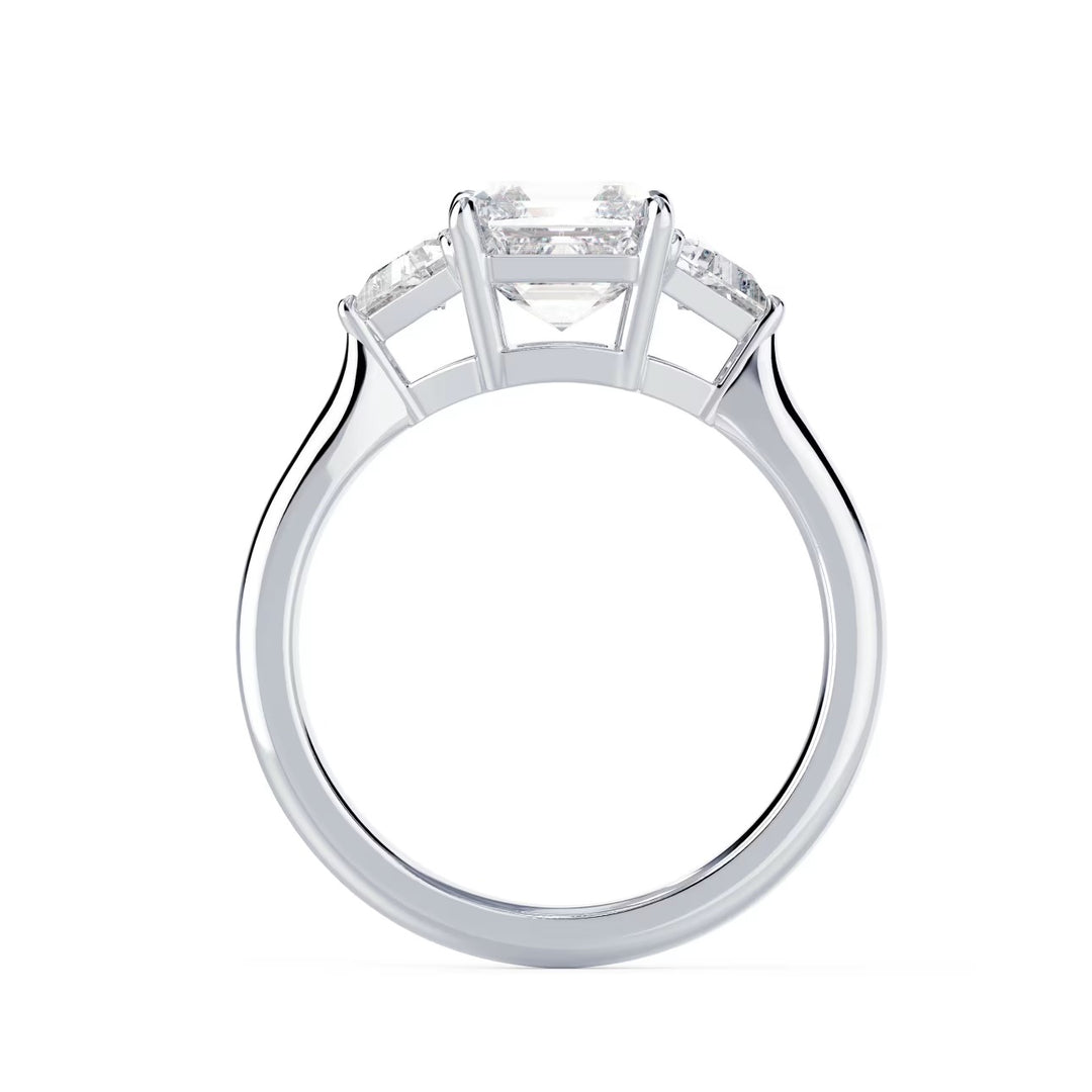 Close-up sparkle of Asscher cut lab grown diamond three stone engagement ring with E VS1 clarity and geometric step-cut brilliance