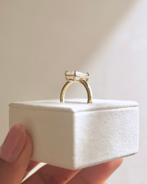 Emerald cut lab diamond solitaire engagement ring featuring a smooth bezel frame and minimalist modern aesthetic