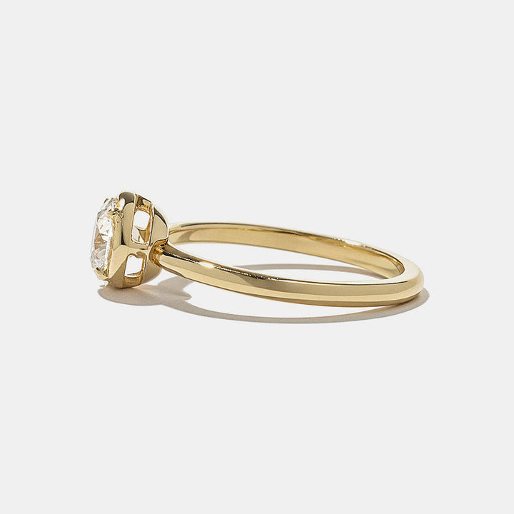  Side profile of round lab diamond bezel engagement ring highlighting low profile secure setting and sleek structure