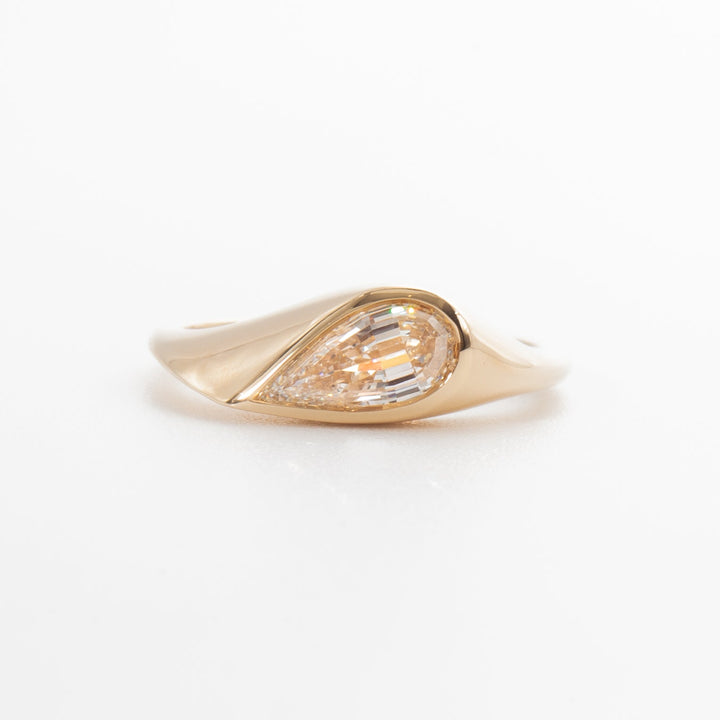 Classic pear cut lab grown diamond bezel engagement ring with antique inspired design and refined craftsmanship