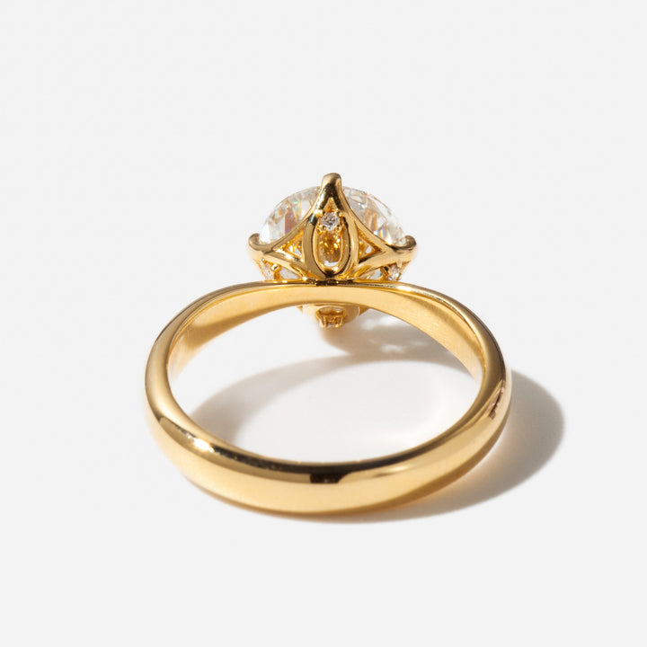 Classic round cut lab grown diamond solitaire engagement ring set in a polished gold band
