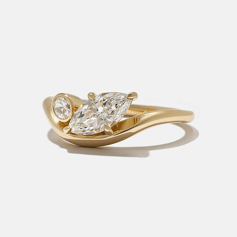 Contemporary engagement ring featuring marquise and oval lab grown diamonds in bezel Toi Et Moi design with clean modern aesthetic