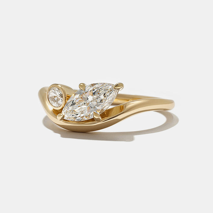 Contemporary engagement ring featuring marquise and oval lab grown diamonds in bezel Toi Et Moi design with clean modern aesthetic