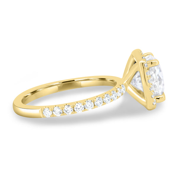 Side profile of cushion lab diamond halo pavé engagement ring highlighting elegant prong setting and pavé band