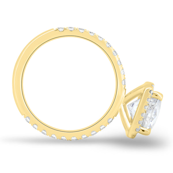 Close-up of cushion cut lab grown diamond halo pavé engagement ring showing sparkling side stones and refined halo setting