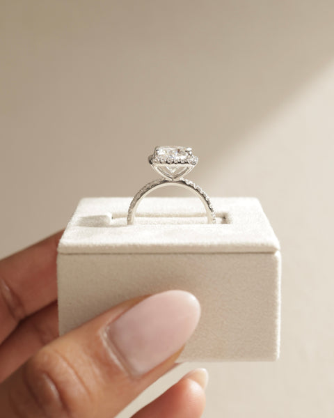 Detailed view of cushion E VS2 lab grown diamond halo pavé engagement ring showing clarity and pavé sparkle