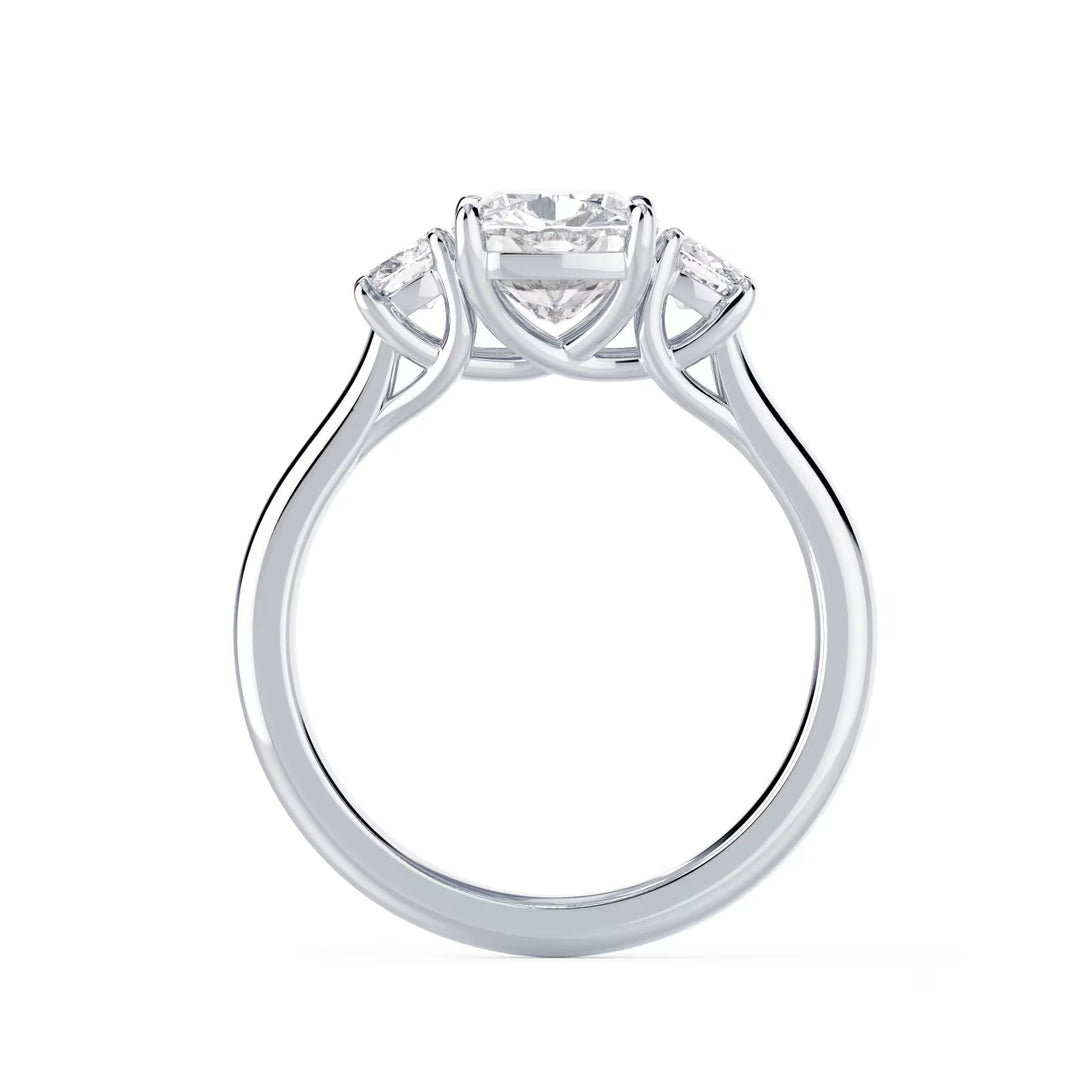 Close-up of cushion cut lab grown diamond three stone engagement ring with E VS1 clarity and radiant sparkle
