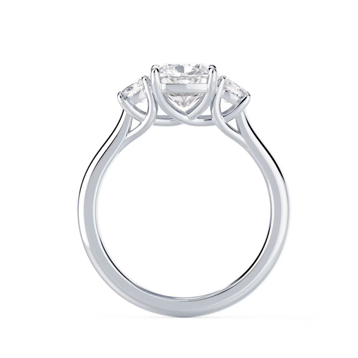 Close-up of cushion cut lab grown diamond three stone engagement ring with E VS1 clarity and radiant sparkle