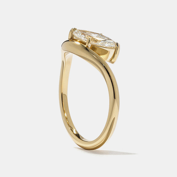 Detailed view of marquise and oval lab diamond bezel Toi Et Moi engagement ring highlighting contrast and clean modern lines