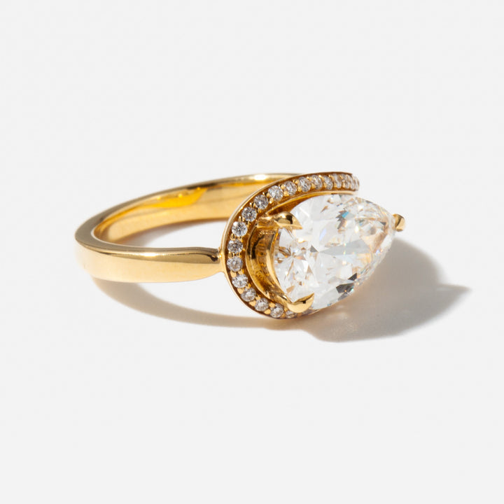 Detailed view of an E VS1 east west pear cut lab grown diamond engagement ring showing modern elongated design