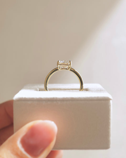 Detailed view of bezel set emerald E VS1 lab grown diamond engagement ring showing precision workmanship and refined details