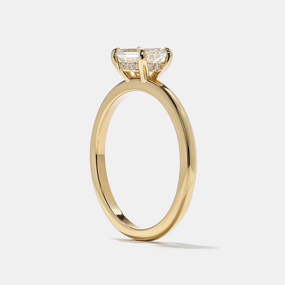 E VS1 emerald cut lab grown diamond hidden halo engagement ring featuring clean step cut facets and subtle halo glow
