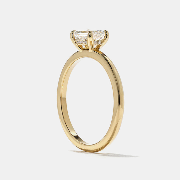 E VS1 emerald cut lab grown diamond hidden halo engagement ring featuring clean step cut facets and subtle halo glow