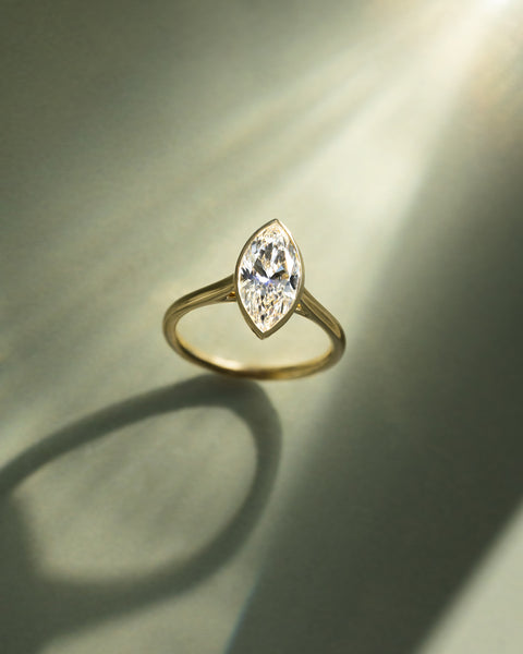 Detailed view of bezel set marquise E VS1 lab grown diamond engagement ring showing precision workmanship and clean lines