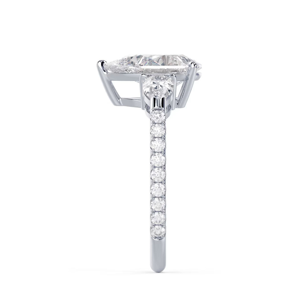 Detailed view of an E VS1 pear shaped lab grown diamond engagement ring with three stone pave design