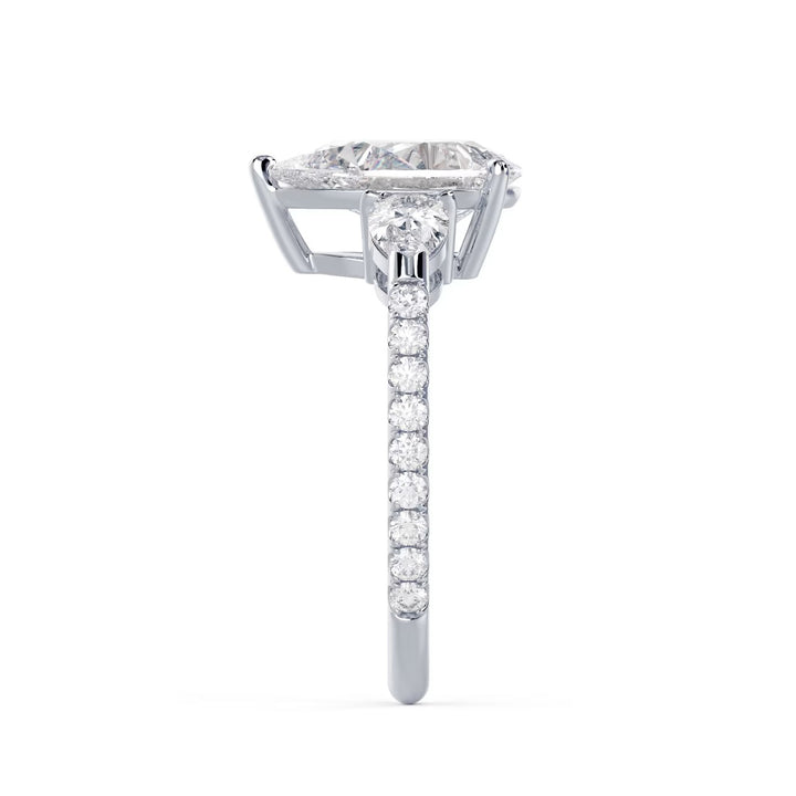 Detailed view of an E VS1 pear shaped lab grown diamond engagement ring with three stone pave design