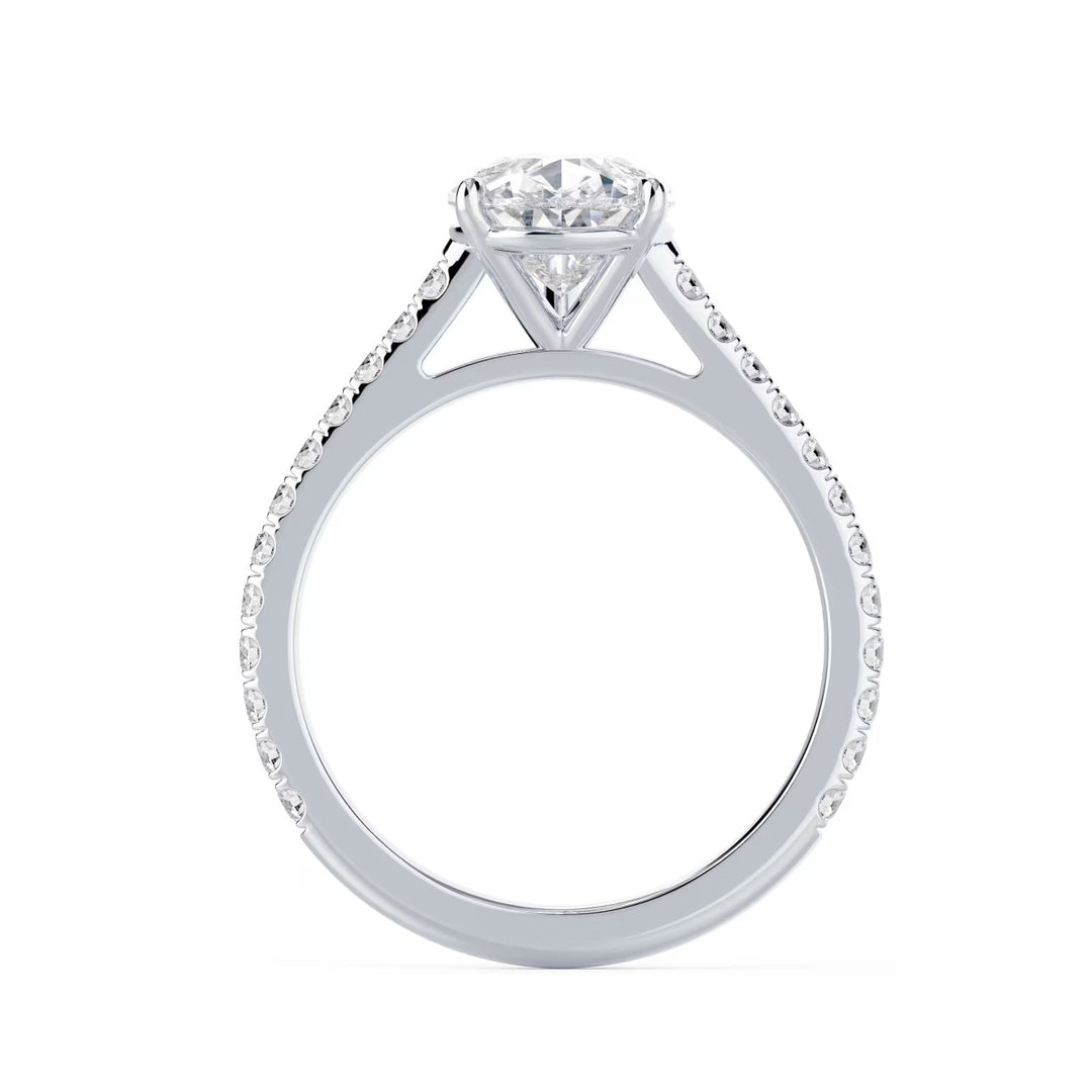 Detailed view of an E VS2 pear cut lab grown diamond cathedral pave engagement ring with elegant elongated shape