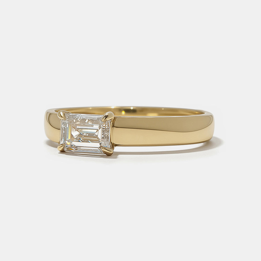 Close-up of east west emerald cut lab grown diamond cigar band engagement ring showing horizontal setting and clean step-cut facets