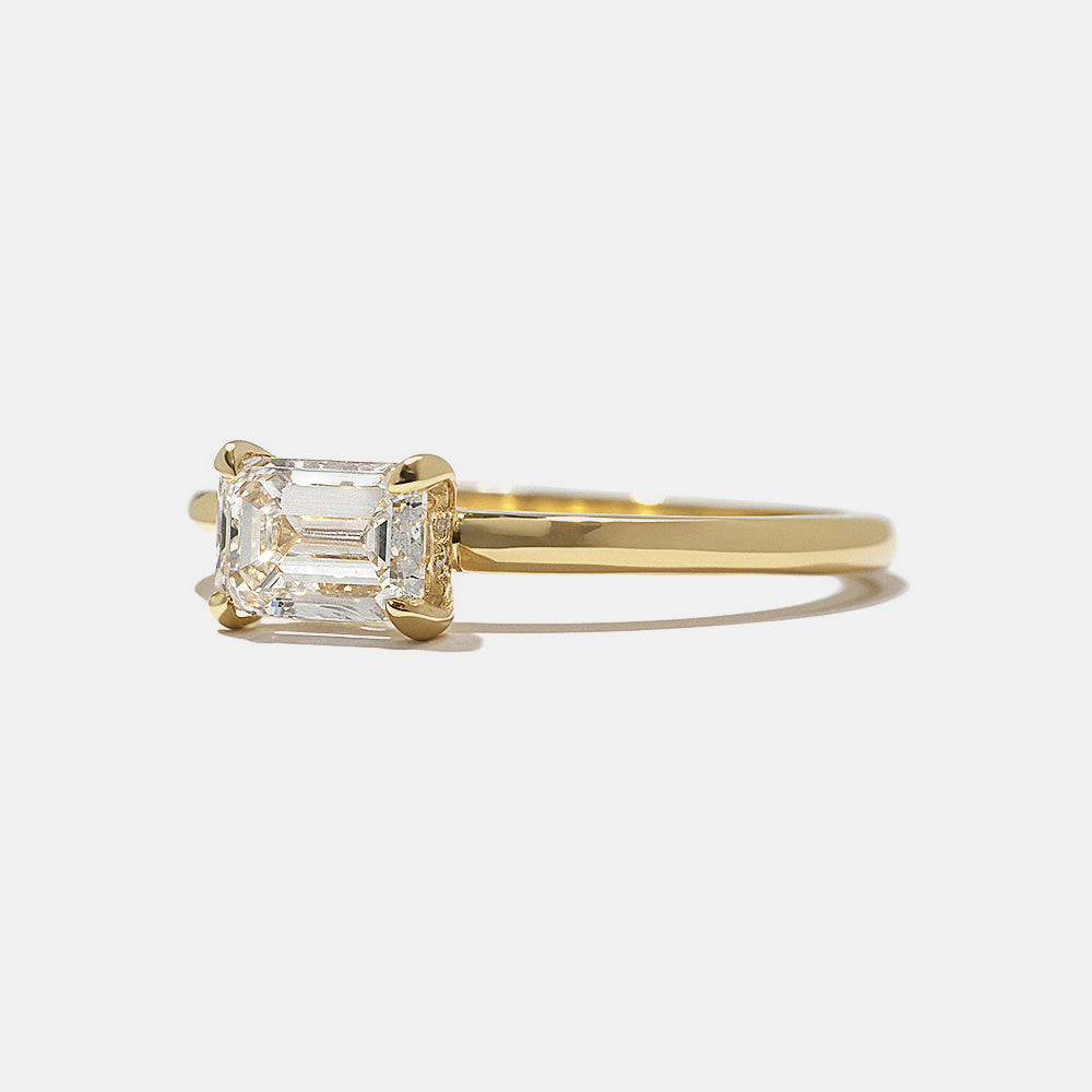 Close-up of east west emerald cut lab grown diamond engagement ring showing hidden halo sparkle beneath center stone
