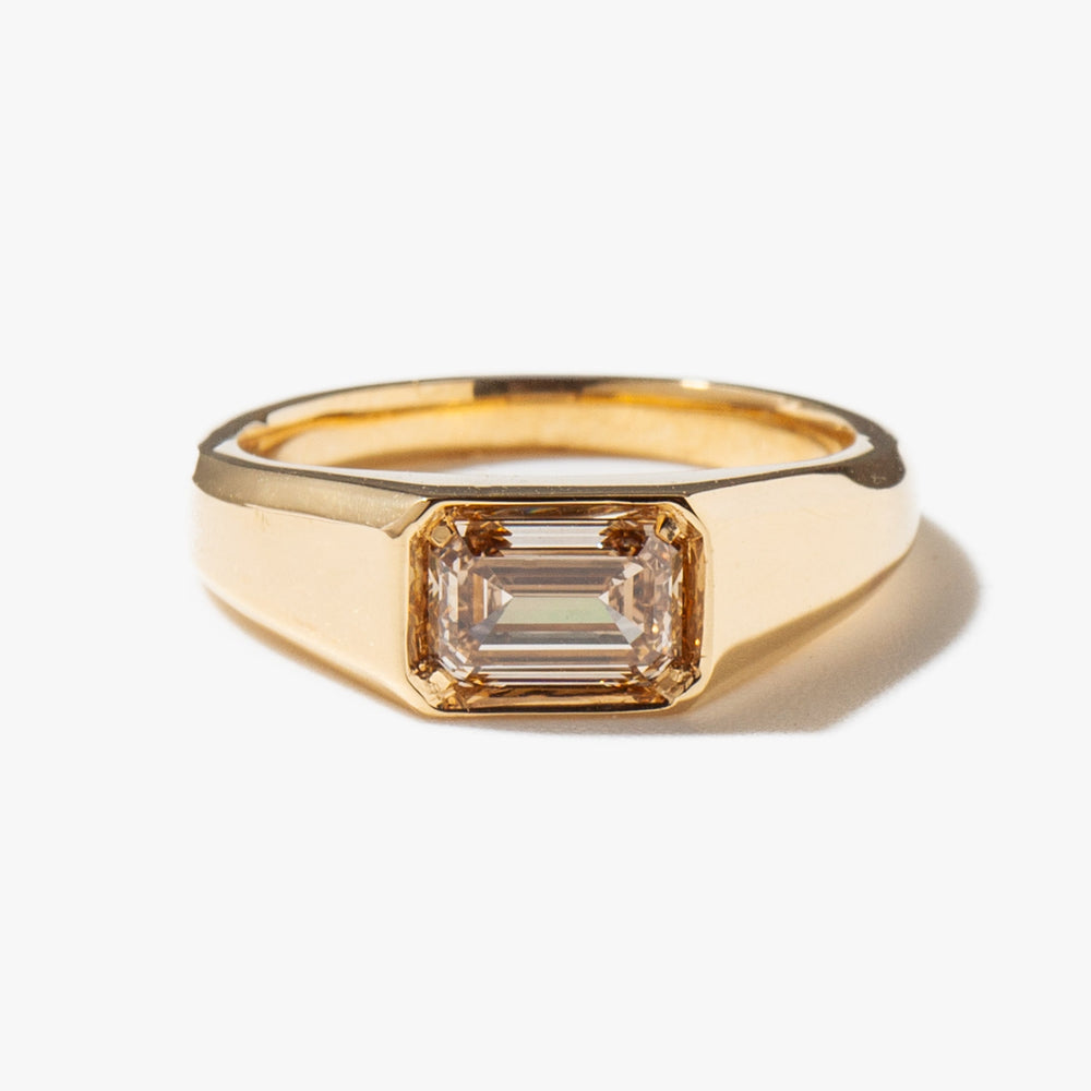Close-up of east west emerald cut lab grown diamond signet ring showing step-cut facets and E VS1 clarity