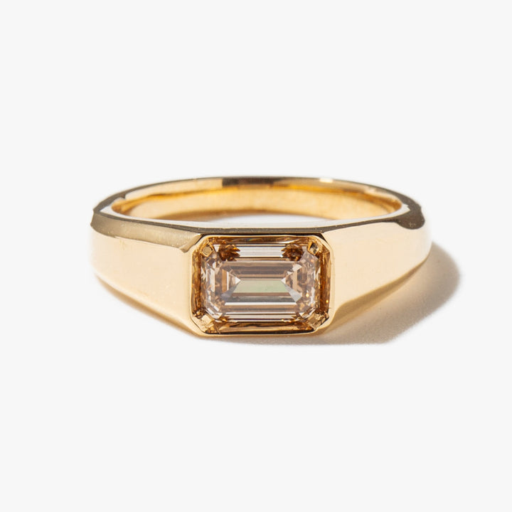 Close-up of east west emerald cut lab grown diamond signet ring showing step-cut facets and E VS1 clarity