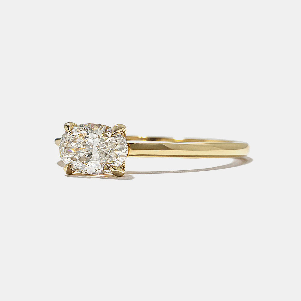 Close-up of east west oval lab grown diamond engagement ring showing hidden halo sparkle beneath center stone