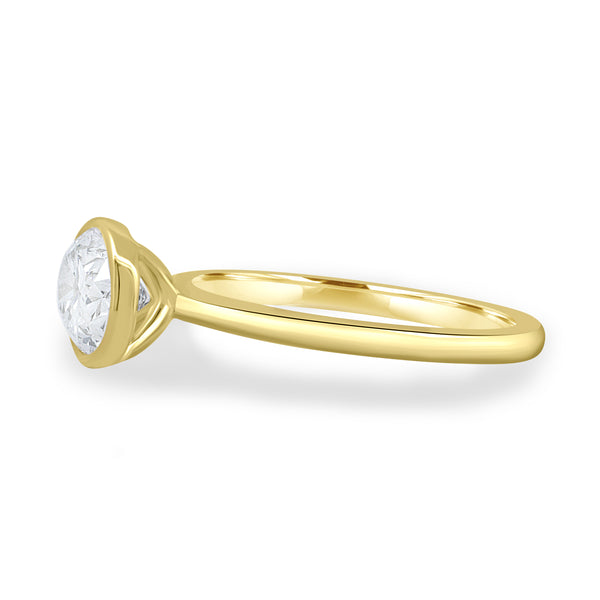 Side profile of bezel set oval E VS1 lab grown diamond engagement ring highlighting sleek structure and minimalist design