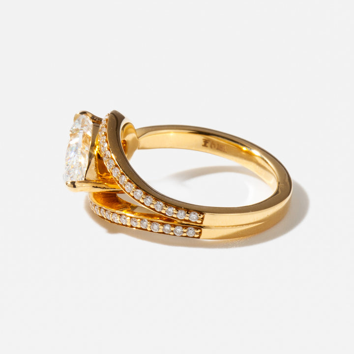 Side profile of a 2.5 carat east west pear cut lab diamond engagement ring showing sleek low-profile setting
