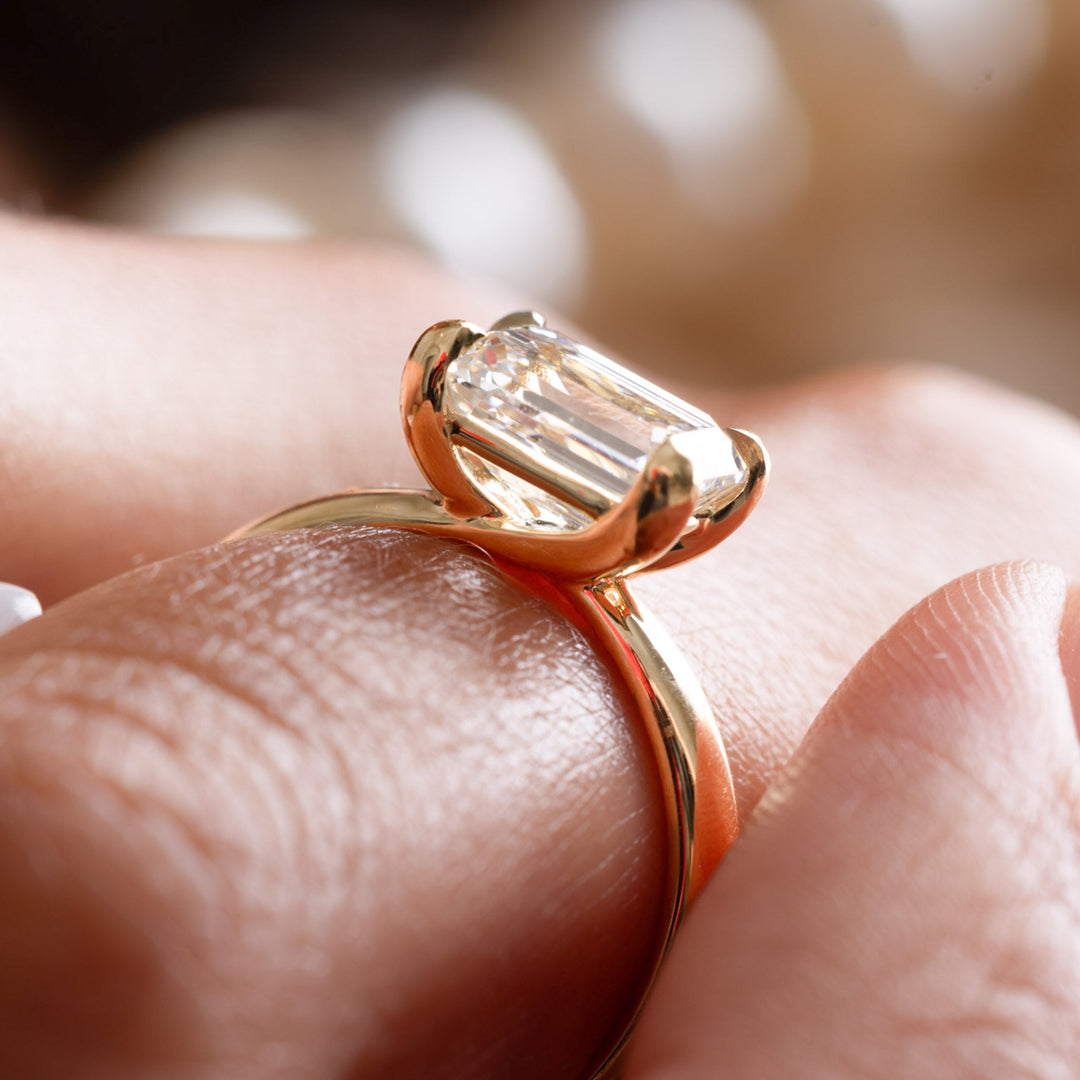 Elegant horizontal emerald cut lab diamond solitaire engagement ring with refined minimalist styling