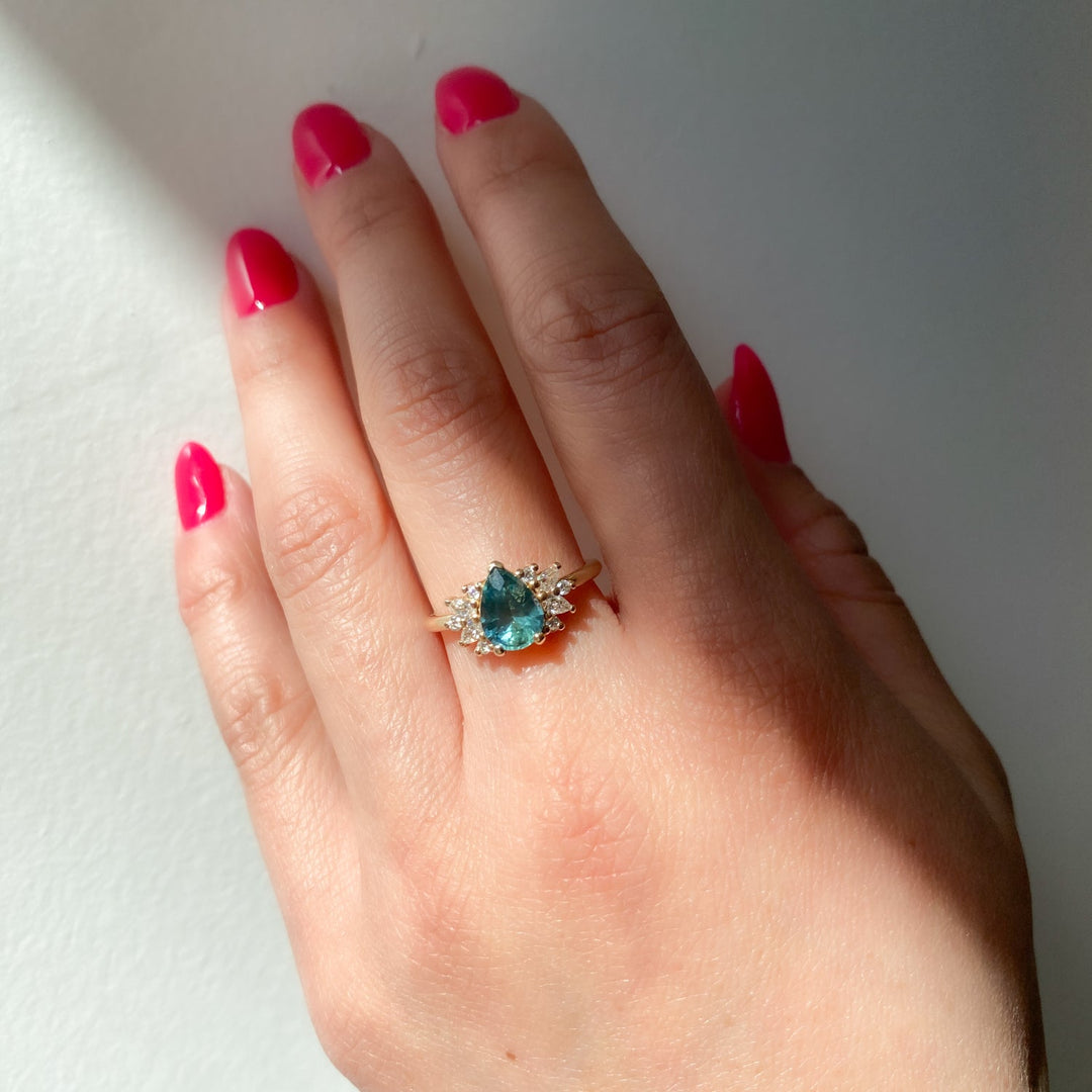 Elegant floral cluster engagement ring featuring pear sapphire center stone and lab grown diamond accents