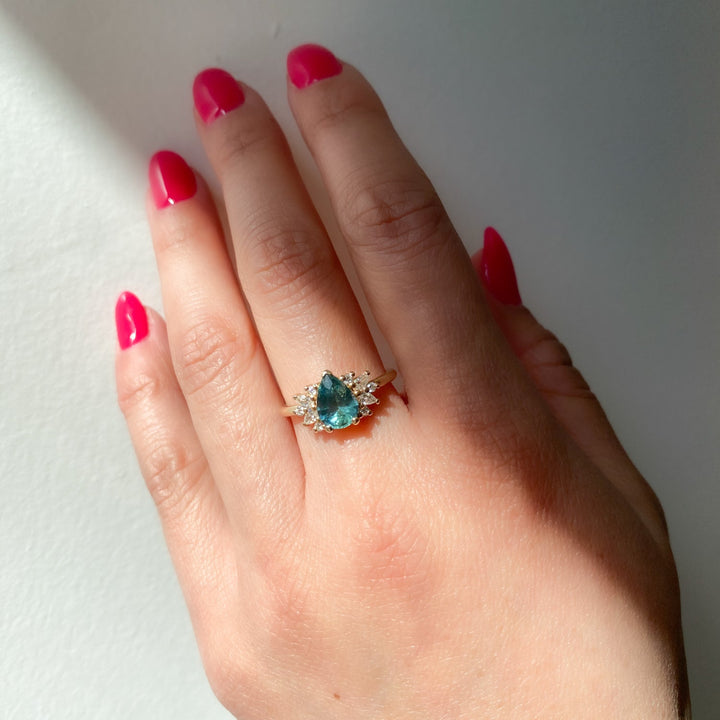 Elegant floral cluster engagement ring featuring pear sapphire center stone and lab grown diamond accents