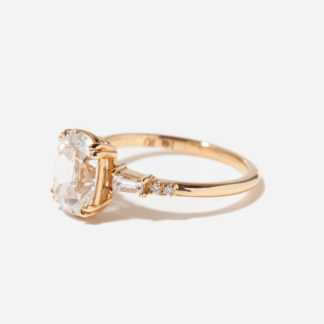 Close-up of elongated cushion cut lab diamond engagement ring showing antique pavé band detailing and refined sparkle